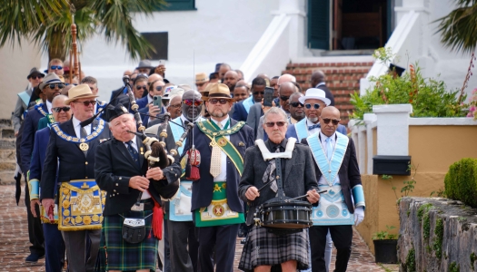 A group of men are walking during the Peppercorn Ceremony