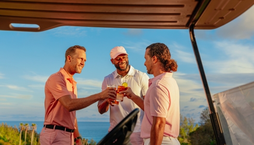 A group of guys are cheersing on the course.