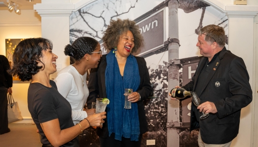A group of people are smiling talking.