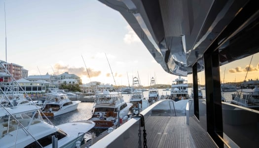 Eye level view of a Super Yacht by fishing boats.
