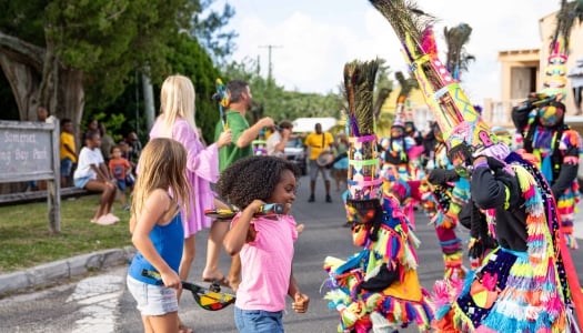 A little girl is dancing with gombey troupes.