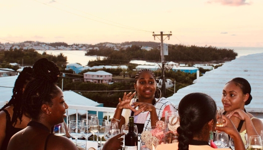 A group of girlfriends having dinner on a rooftop