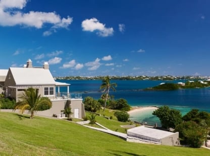 A building on a hill overlooking the water