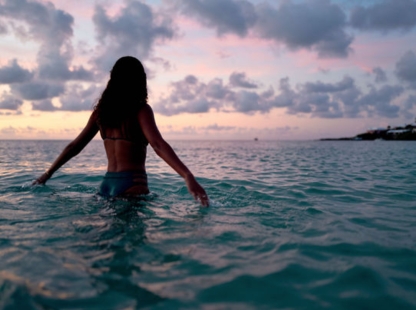 A woman in the water on a beach in Bermuda