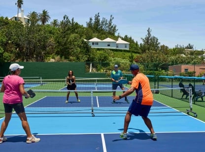 A group of people are playing pickleball