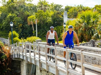 Two men riding bicycles.