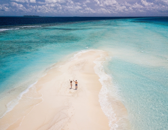 two people on a sand bar