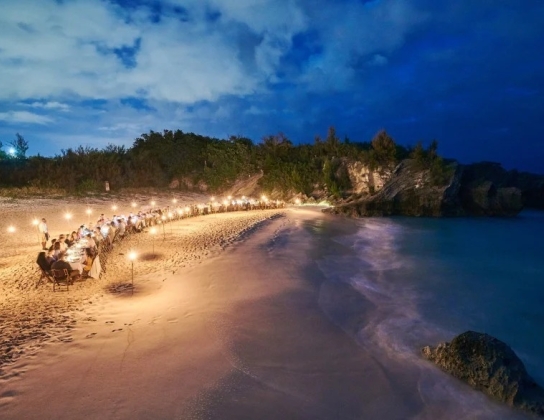 people dining at the beach at night