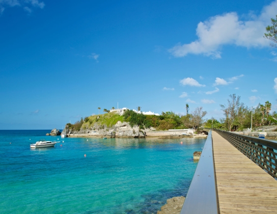 wooden bridge crossing over a body of water along the Bermudian coastline