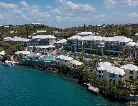 Aerial view of Newstead Belmont hotel with a lush greenery and a pool.