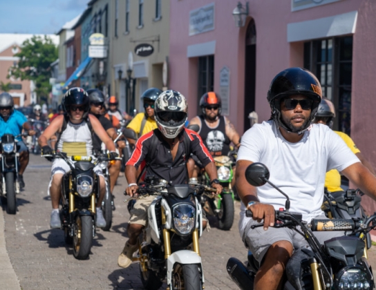 A group of guys are riding motorcycles