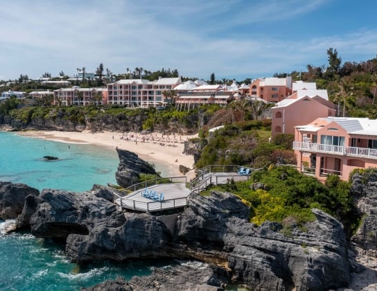 Birds eye view of The Reefs with deck and beach.