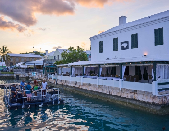 Exterior view of White Horse with band on floating dock.