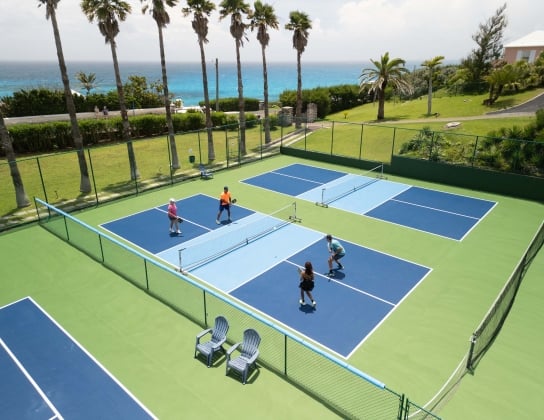 An aerial view of a group of people are playing pickleball.