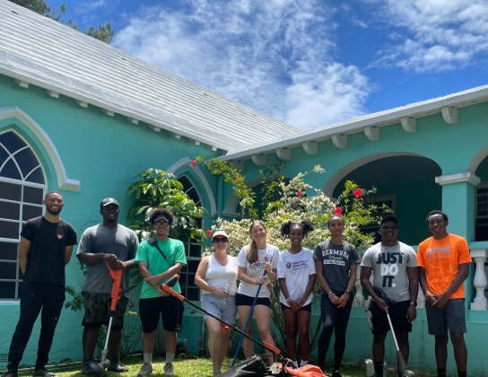 A group of people are volunteering at a Bermuda is Love event.