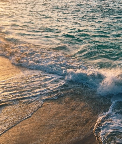 Waves crashing on the beach during sunset