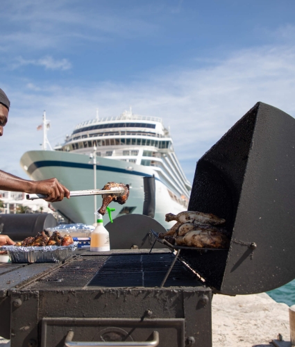A man BBQing chicken on the docks in Bermuda