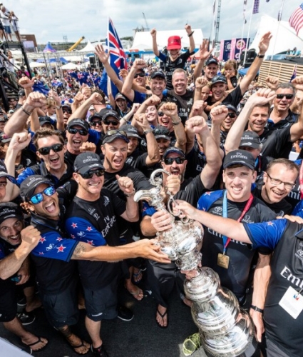 crowd of racers celebrating with a trophy