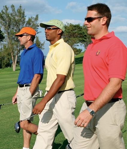 Three men walking a golf course