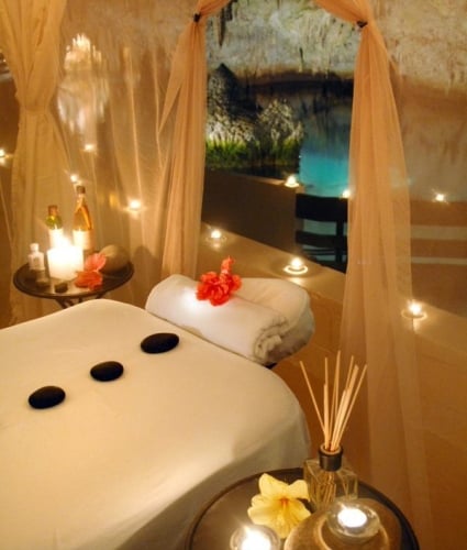 A soothing massage table in Bermuda features hot stones, flowers and candles.