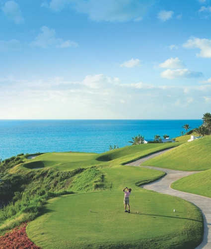 Man teeing off at Port Royal Golf Course with a view of the ocean