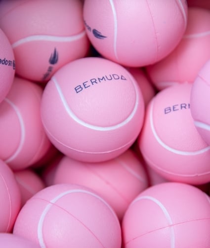 close up image of pink tennis balls with the word Bermuda printed across them
