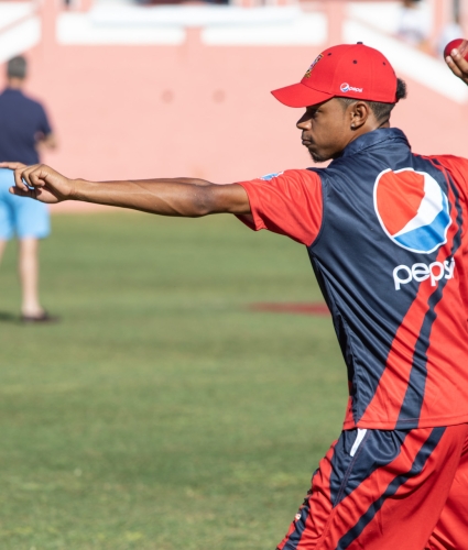 Cricket pitcher winding up to throw