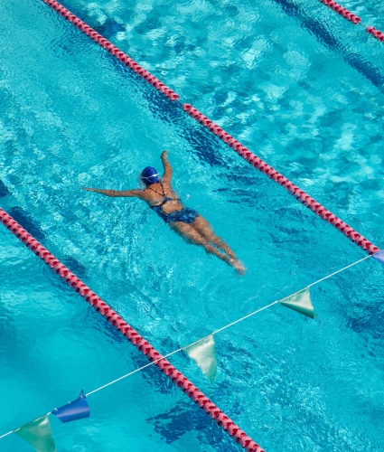 Aerial shot of woman swimming laps at the National Stadium pool