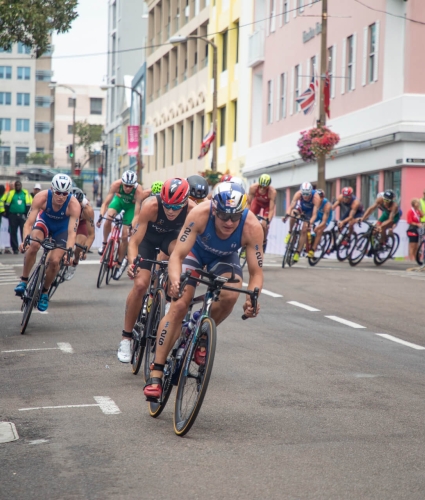cyclists race down the street - competing in a triathlon in Bermuda
