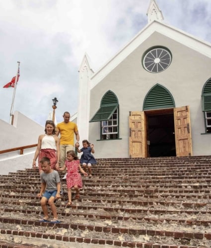 Family walking down stairs from a church.