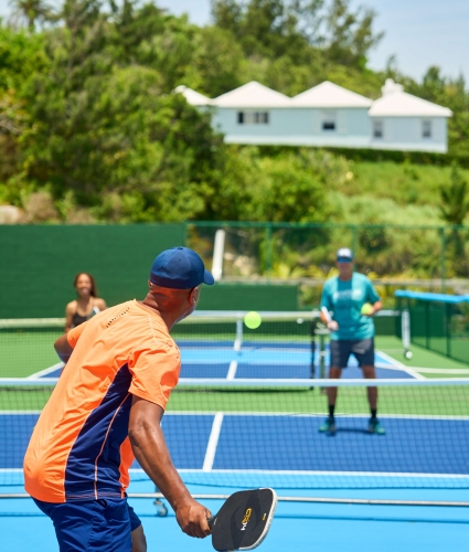 A group of people are playing pickleball