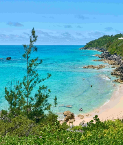 Aerial view of people swimming at the quiet Church Bay.