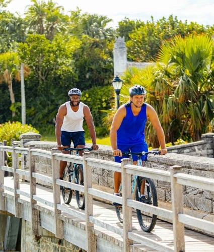 Two men riding bicycles.