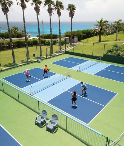 An aerial view of a group of people are playing pickleball.