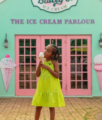 A little girl is eating ice cream.