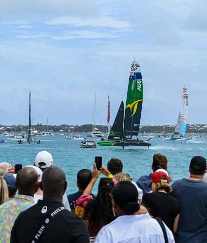 A group of people are watching the sail grand prix.