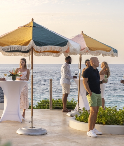 A group of people standing by the poolside.
