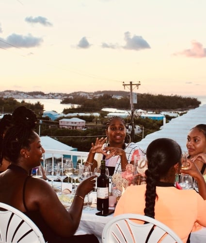 A group of girlfriends having dinner on a rooftop