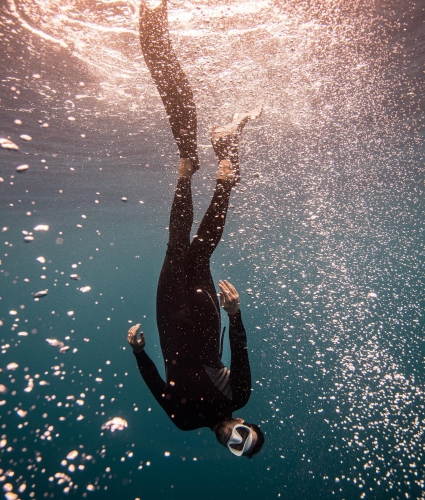 A snorkeler diving into the ocean