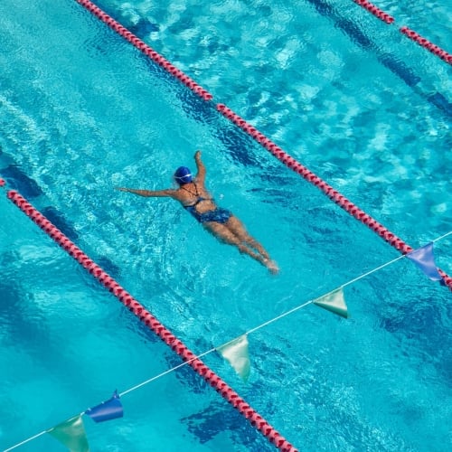 Person swimming in lap pool