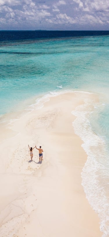 two people on a sand bar