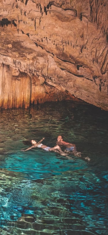 A couple floating in a cave in Bermuda