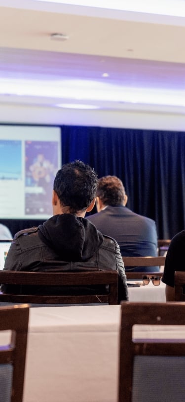 A group of people are watching a presentation.