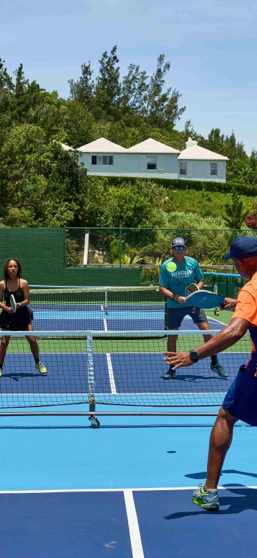 A group of people are playing pickleball