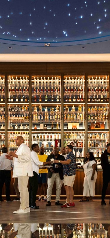 A group of people are standing in the Bacardi Headquarters building.