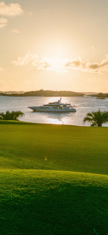 A super yacht is in Bermuda by a golf course