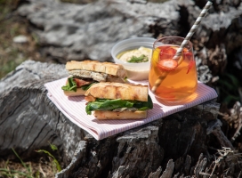 a sandwich and ice tea on a plate
