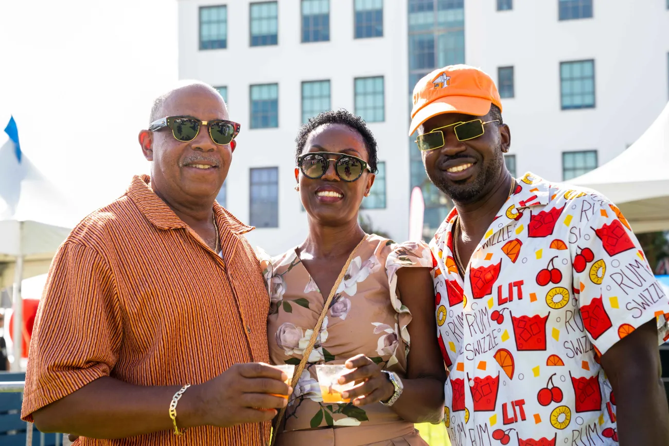 A group of people are standing holding swizzles.