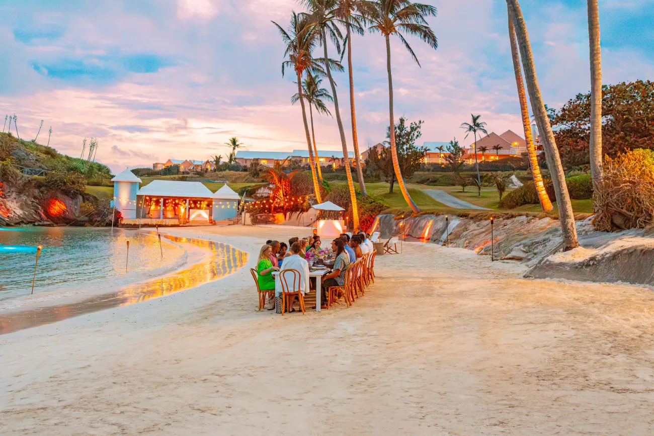 A group are experience a special dinner on the beach.