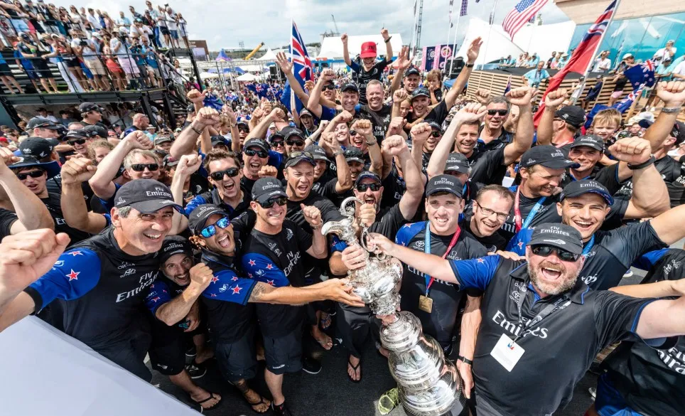 crowd of racers celebrating with a trophy